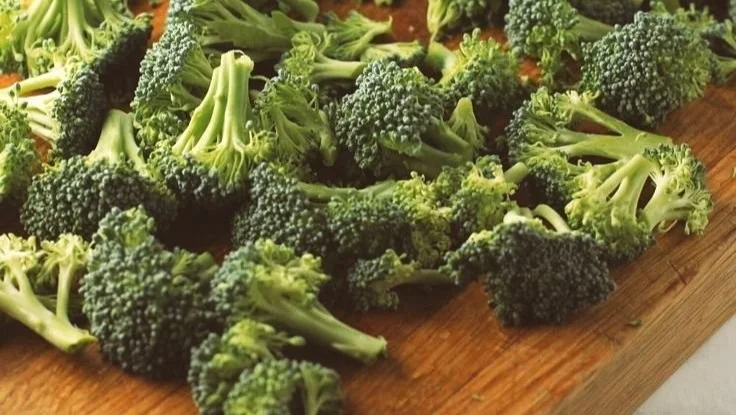 Delicious bowl of broccoli cheddar soup garnished with fresh broccoli