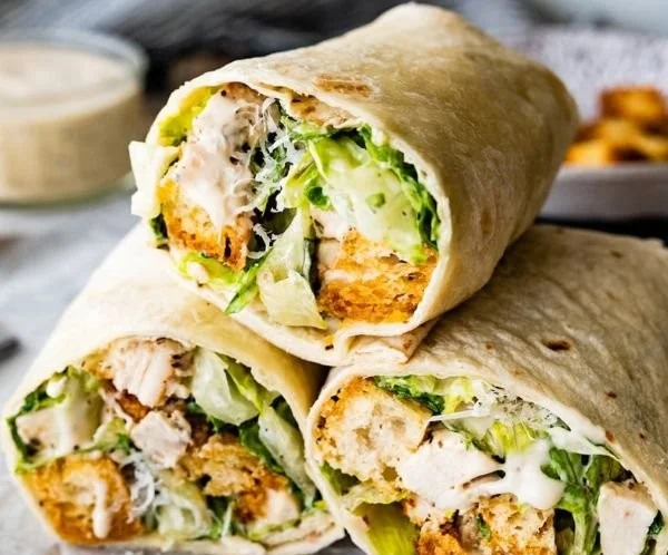 Delicious Chicken Caesar Wrap with grilled chicken, romaine lettuce, and Caesar dressing.