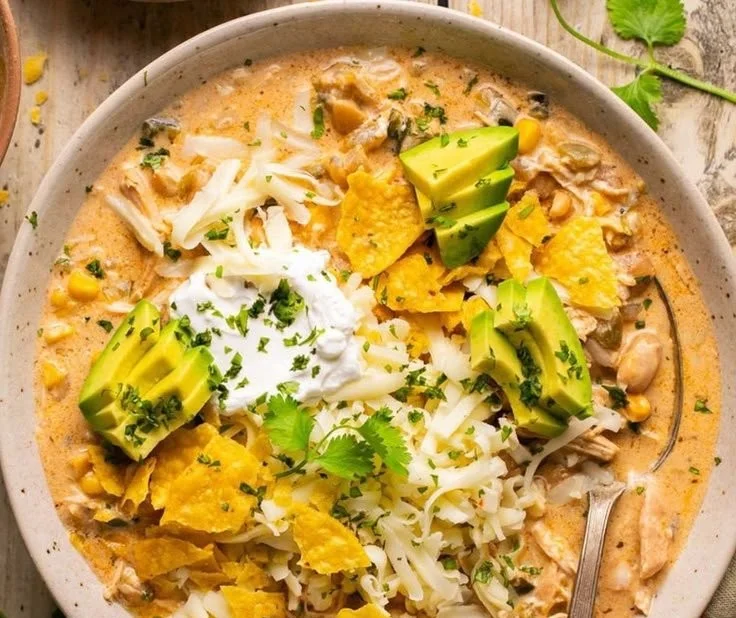 Bowl of healthy white chicken chili topped with cilantro and lime.