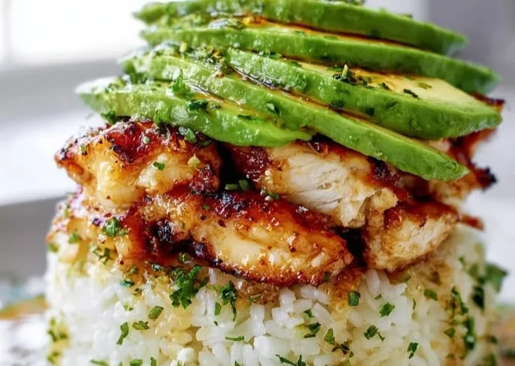 Honey Lime Chicken Avocado Rice Stack served on a plate with garnishes