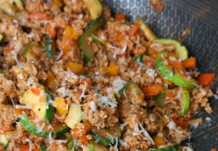 Italian Ground Turkey and Veggie Skillet topped with fresh herbs and veggies