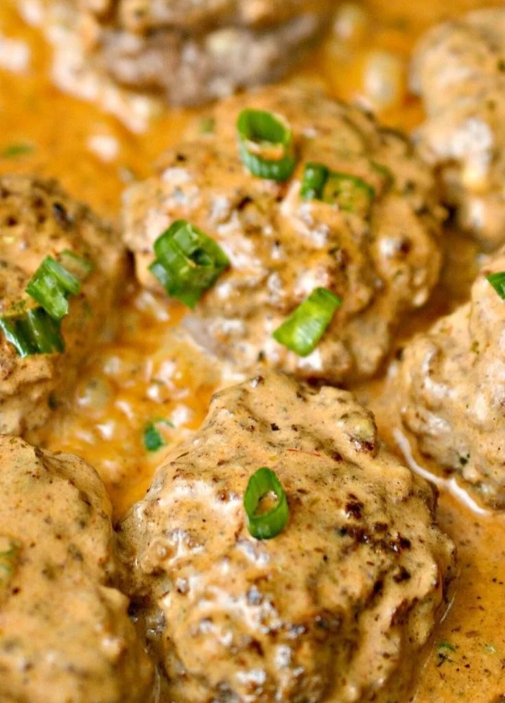 Keto Feta Burgers served with tomato cream sauce on a plate