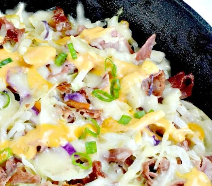Keto Reuben Bowl topped with corned beef, cheese, and sauerkraut in a bowl.