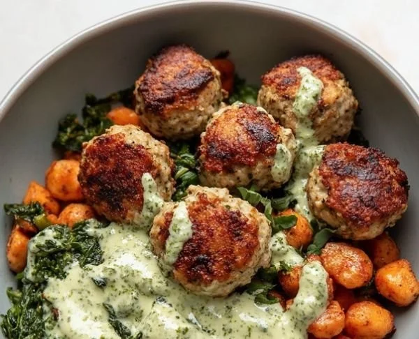 Mediterranean chicken meatball bowls with fresh vegetables and herbs