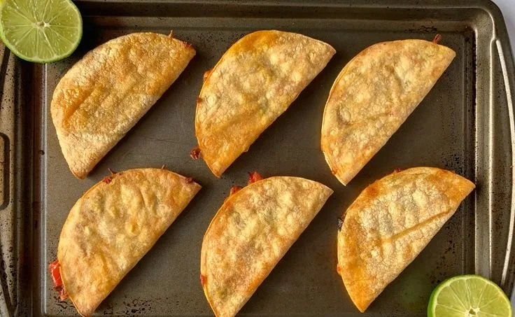 Plate of minute baked chicken tacos topped with fresh toppings.