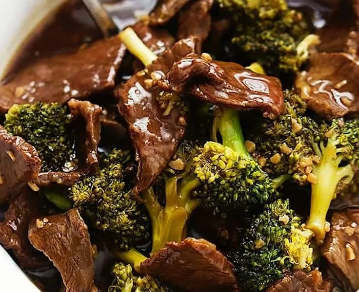 Delicious slow cooker broccoli beef served with rice on a plate