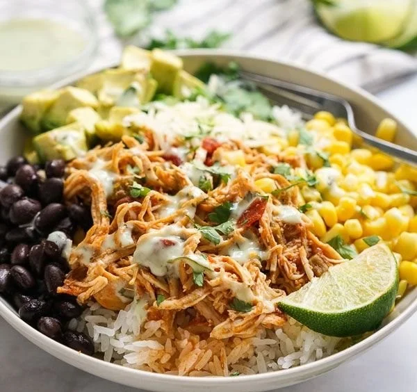 Slow Cooker Chicken Burrito Bowls with rice, beans, and fresh toppings